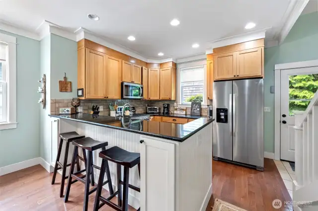 Stainless steel appliances, smart storage and additional seating in this hard working kitchen.