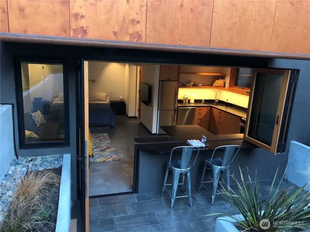 ADU outside bar seating & accordion windows opened.