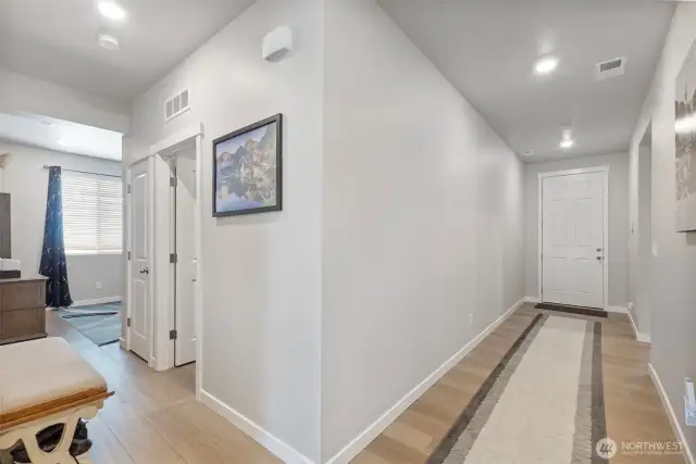Hall showing access to laundry room, garage, office at left.