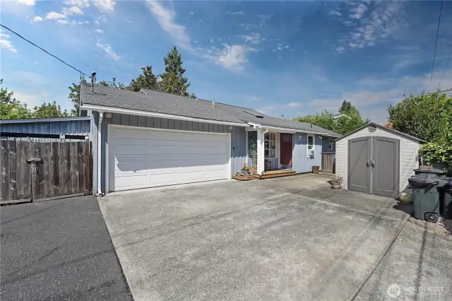 Front of home with exterior storage shed and extra parking