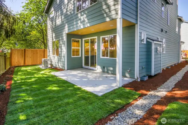 Fully fenced backyard with covered patio