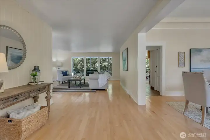 From entry:  main level living room, dining to right and kitchen through hallway.  Main level bed and bath to the right, past dining room.  Slider to covered porch through kitchen.  Hardwood floors.  Fresh paint throughout.