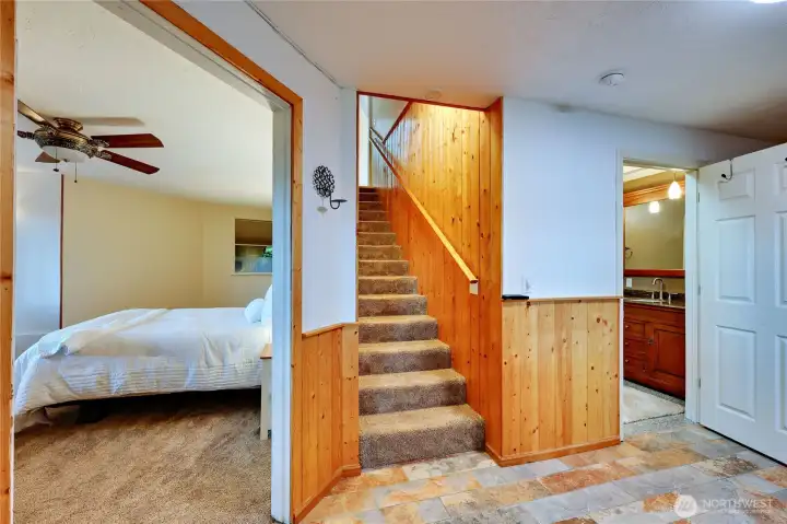 Downstairs suite. Bedroom on the left, 3/4 bathroom on the right with entry way to outside. Could be someone's separate quarters.