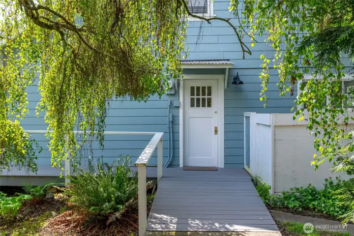 Main house side door leads through the utility/mud room to the kitchen