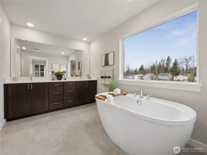 Large primary bath with standalone soaking tub with large window. Photo is representational. Actual home is under construction and finishes and paint colors may vary. See site agent for details.... Large primary bath with standalone soaking tub with large window. Photo is representational. Actual home is under construction and finishes and paint colors may vary. See site agent for details....