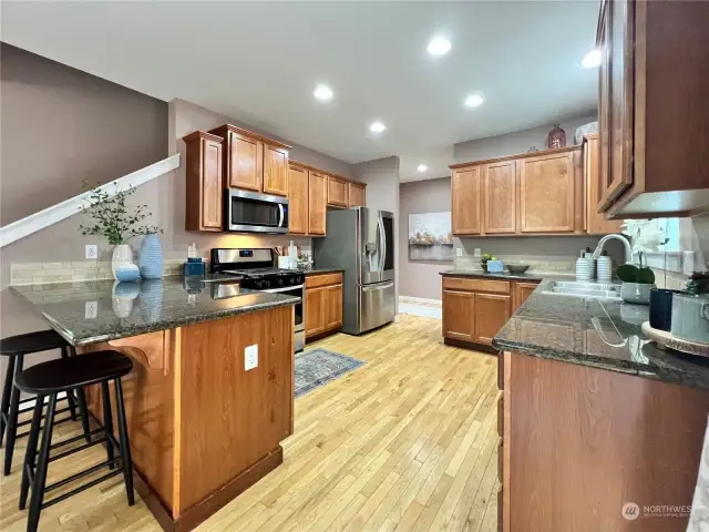 Large kitchen with beautiful wood floors & granite counter tops