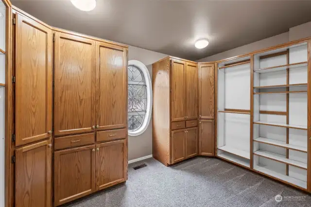 Large walk-in closet with extensive custom built-ins