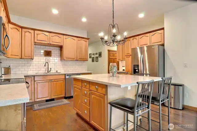 Cozy up on the bar stools and keep the cook company! A great kitchen for entertaining. Easy access to the back decks and the open concept dining area.