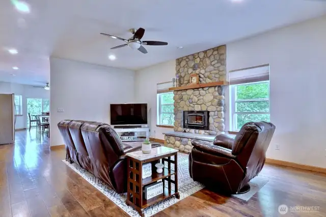 Cozy river rock encapsulates the fireplace and sets the mood for the lakefront vibe. Natural light, beautiful floors and a more to follow.