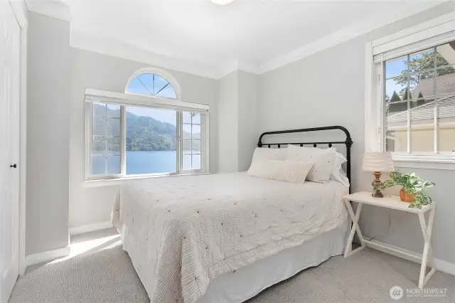 A guest bedroom with view of the lake.