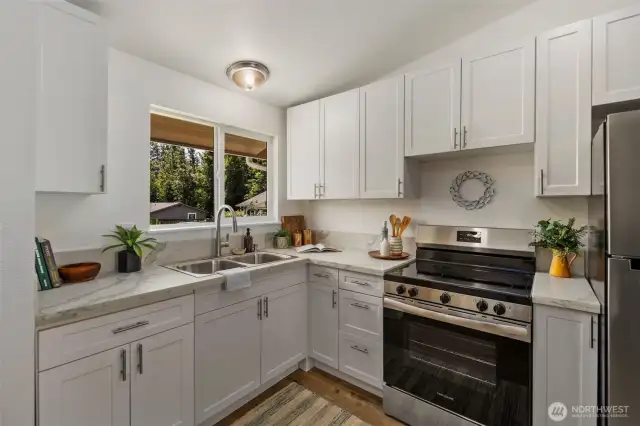 Unit A! Both units are identical. Completely remodeled! Quartz counters, new cabinets, new vinyl hardwood plank flooring, new appliances, new siding, new windows, new plumbing fixtures, new light fixtures, new wall heaters and more!