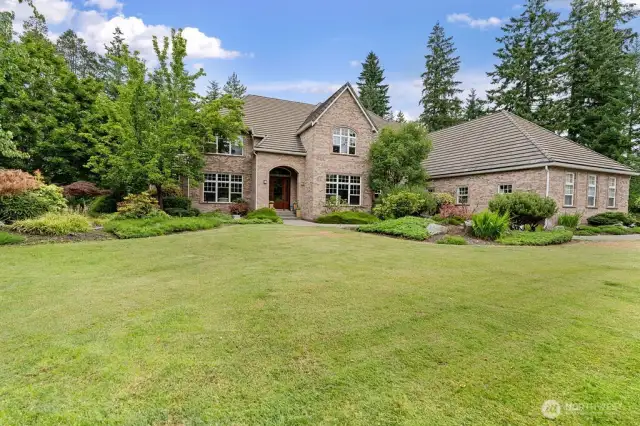At end of a quiet cul-de-sac, nestled on the shore of North Lake, and tucked in beside the 9th hole, this home features .8 acre of privacy and seclusion.