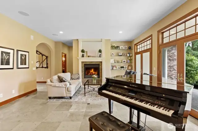 The living room with its fireplace and French patio doors.