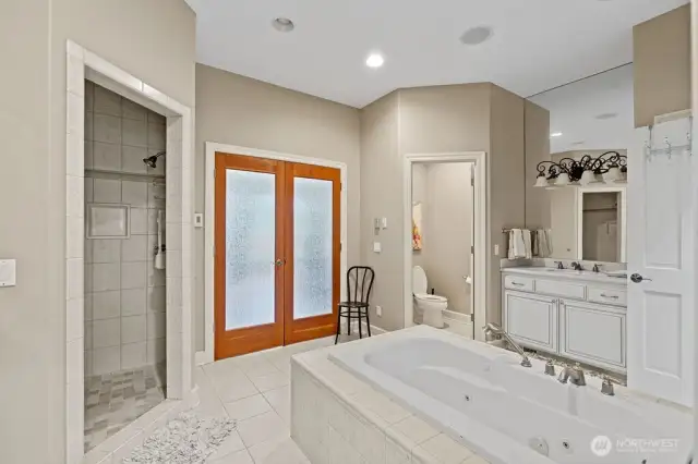 The main level primary bath with jetted tub and separate shower, double vanities and separate toilet room.