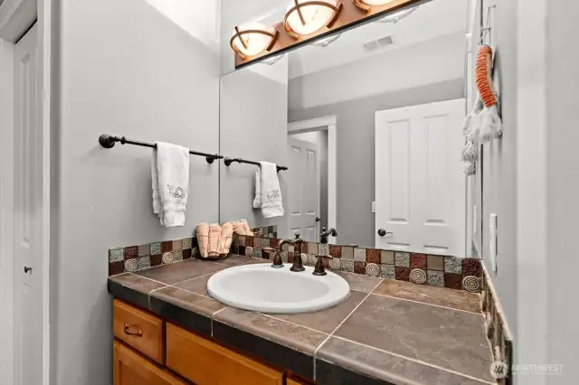 The Jack and Jill bathroom has two separate vanities.