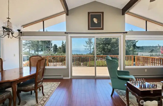 Vaulted ceilings and a western wall of windows maximize your view and your sun exposure. The new expansive deck adds additional square footage for entertaining. Plenty of space for a dining set and plenty of chairs.