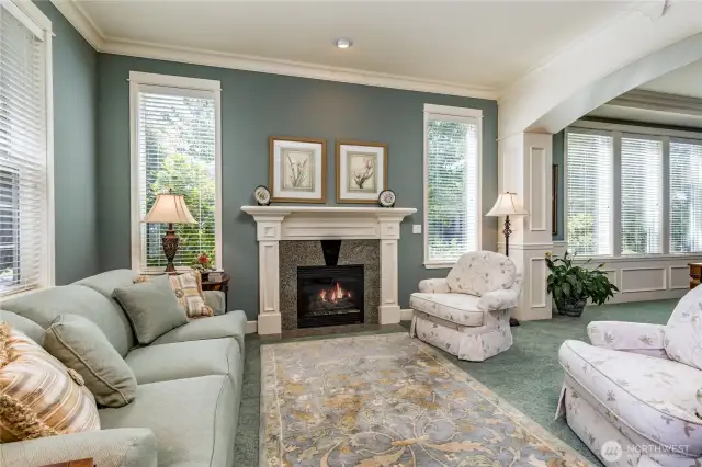 Formal living room features an elegant gas fireplace