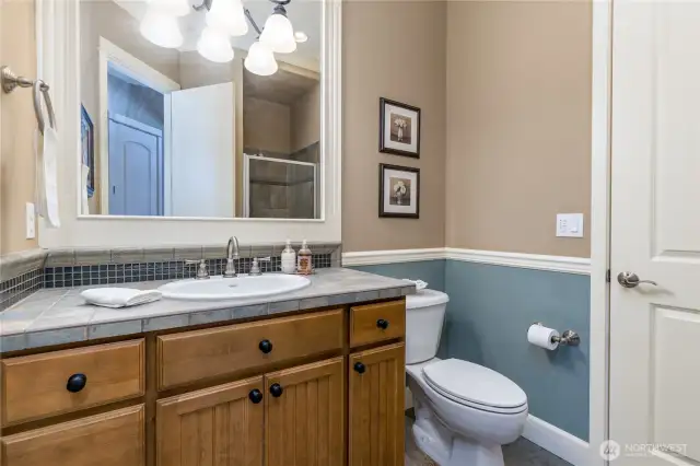 Main floor bathroom with a shower includes direct access from the office