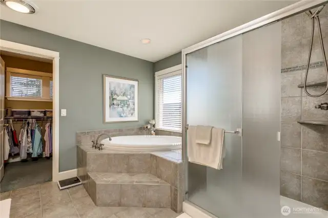 Spacious 5-piece primary bathroom includes designer tile and TWO walk-in closets!