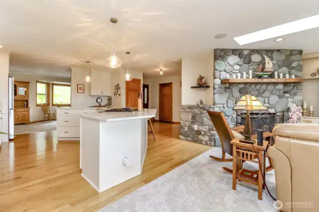 Natural light floods the space through a skylight, complementing the recessed lighting and enhancing the sophisticated ambiance. Plush carpeting adds comfort