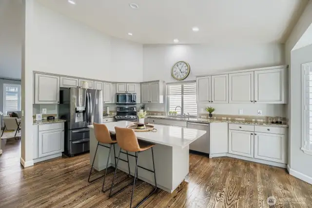 Updated kitchen with vaulted ceilings and tons of counter space (granite and quartz) /Stainless steel appliances