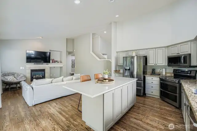Open concept kitchen to living or dining area with gas fireplace
