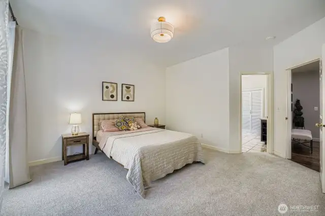 Spacious main floor primary bedroom leading to attached bathroom