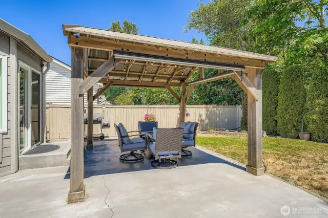 Enjoy this lovely covered patio around the fire year around!