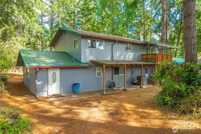 Backside of house, door to the left is exterior entry to studio apartment or secondary master suite, however space decided to be utilized.