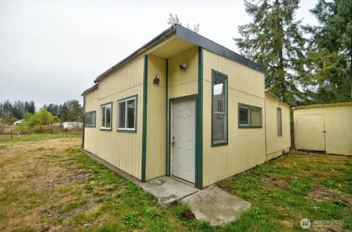 Detached 560 sq ft shop and storage/garden shed.