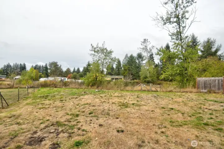 Large lot with green belt behind.