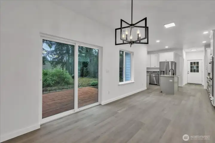 Dining area with triple paned glass slider leading to private back deck.