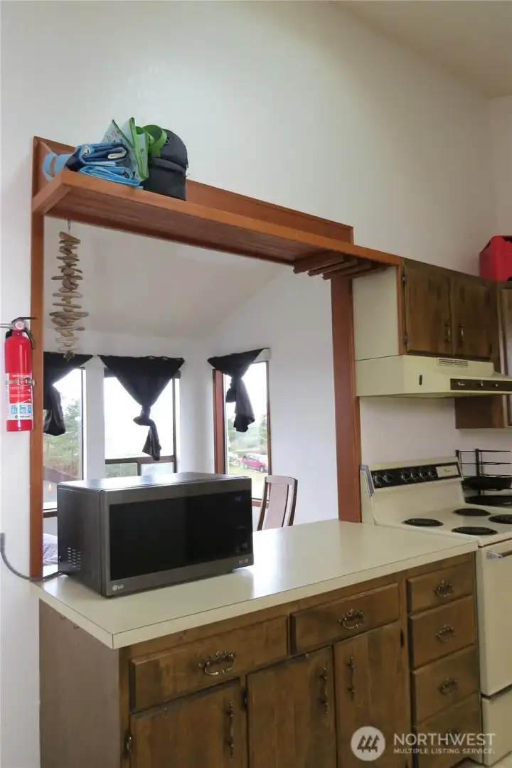 TO THE LEFT OF THE KITCHE IS A PASS-THROUGH TO THE DINING/LIVING AREA!