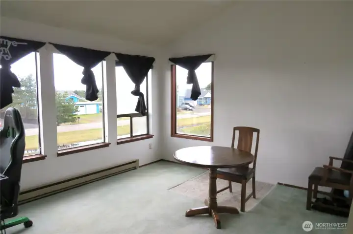 THE LVING ROOM HAS A FULL BANK OF WINDOWS FACING WEST FOR A PEEK-A-BOO VIEW OF THE PACIFIC OCEAN!