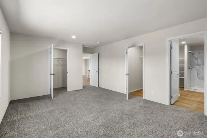Primary bedroom with multiple walk-in closets and a spacious bathroom awaits