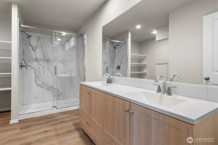 Dual vanities in this primary spa-like bathroom