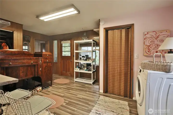 The carport enters here from the back of the house. Behind the curtain is a standing shower.