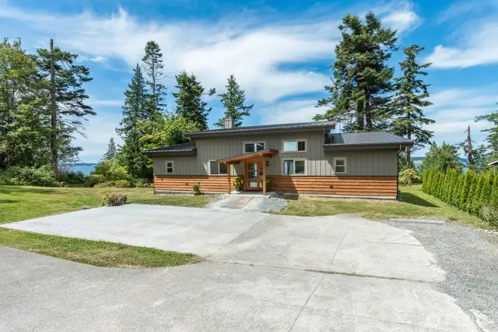 The concrete pad was intended for a garage with a guest quarter above. 3 bedroom newer septic drainfield would have the room for the expansion.