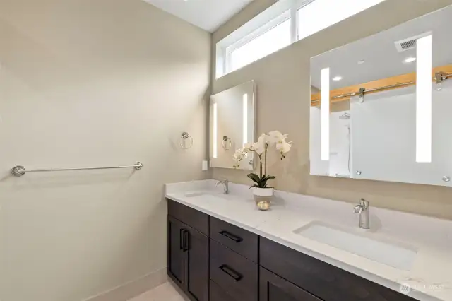Heated tile floor & LED vanity mirrors give primary bath its spa-like feeling