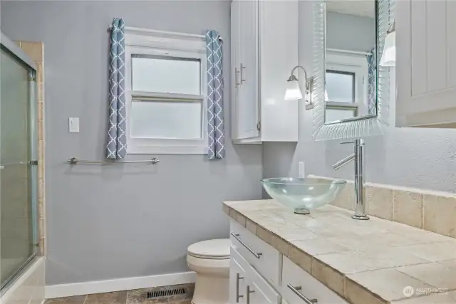 Main floor bathroom with bathtub and shower