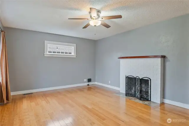 Living room with bamboo flooring and wood burning fireplace