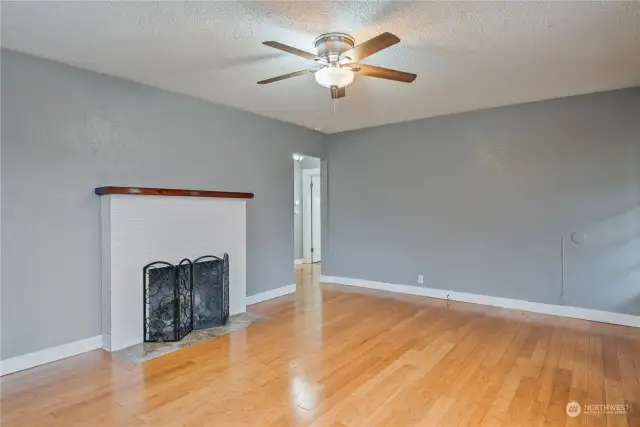 Living room with bamboo flooring and wood burning fireplace