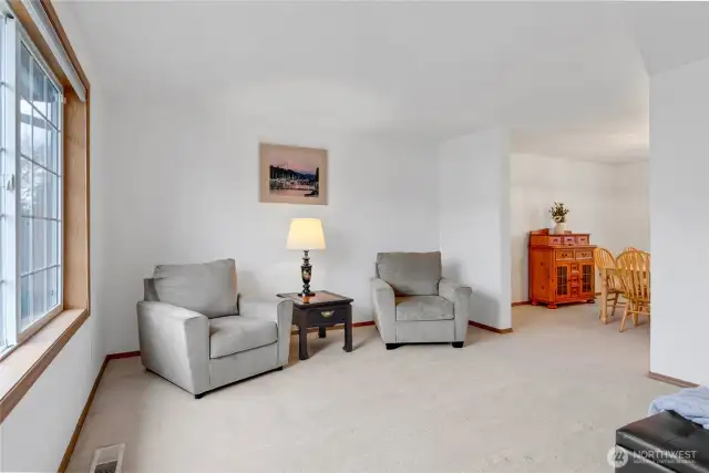 This formal living room is to the left of the entry and includes a large window for ample light. This joins the formal dining room to the right.