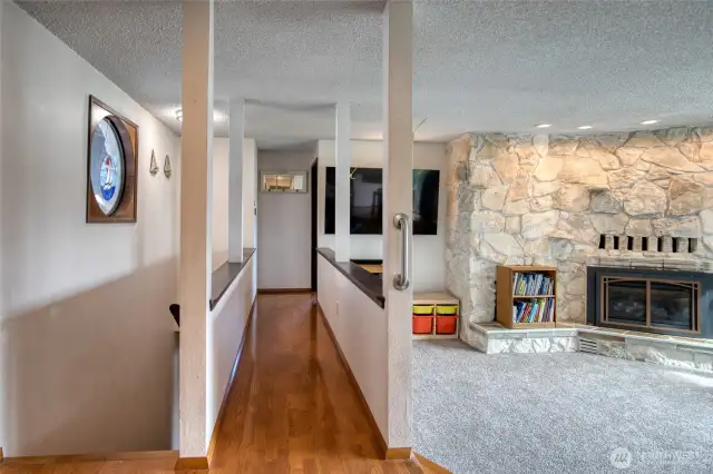 To the right hall leading to primary to the left stairs to lower level.