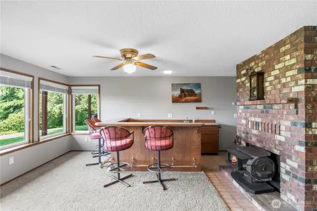 Wet bar in basement with fireplace.