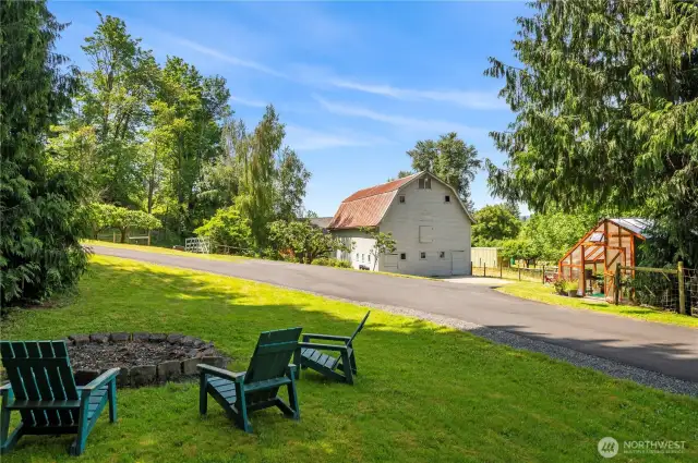 Fire pit, barn, and greenhouse. Barn also features chicken coop.