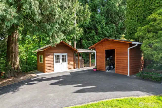 Building with pizza oven on the left, utility shed on the right.