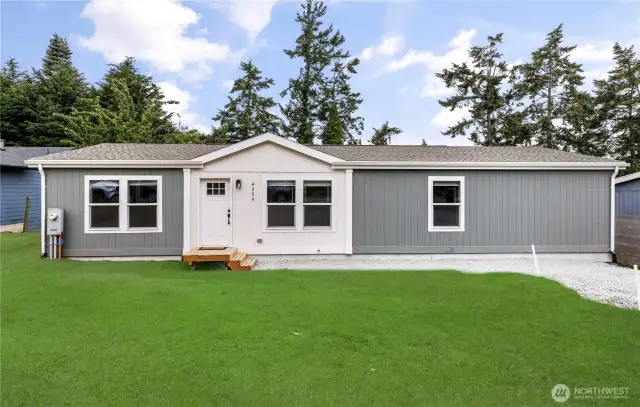 Front of Brand New Home.  3 bedroom 2 full bath.  1493 sqft.  Grass is staged.  Currently front yard seeded and growing.