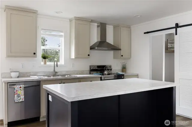 Stainless appliances with classy range hood.  Power on the Island makes it perfect for all your needs