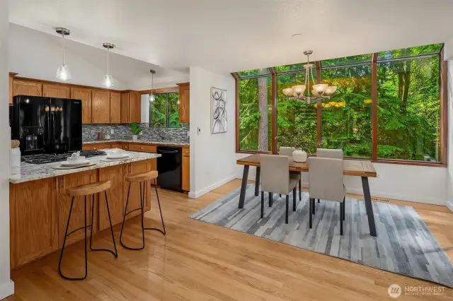 Kitchen and eating space surrounded by nature.